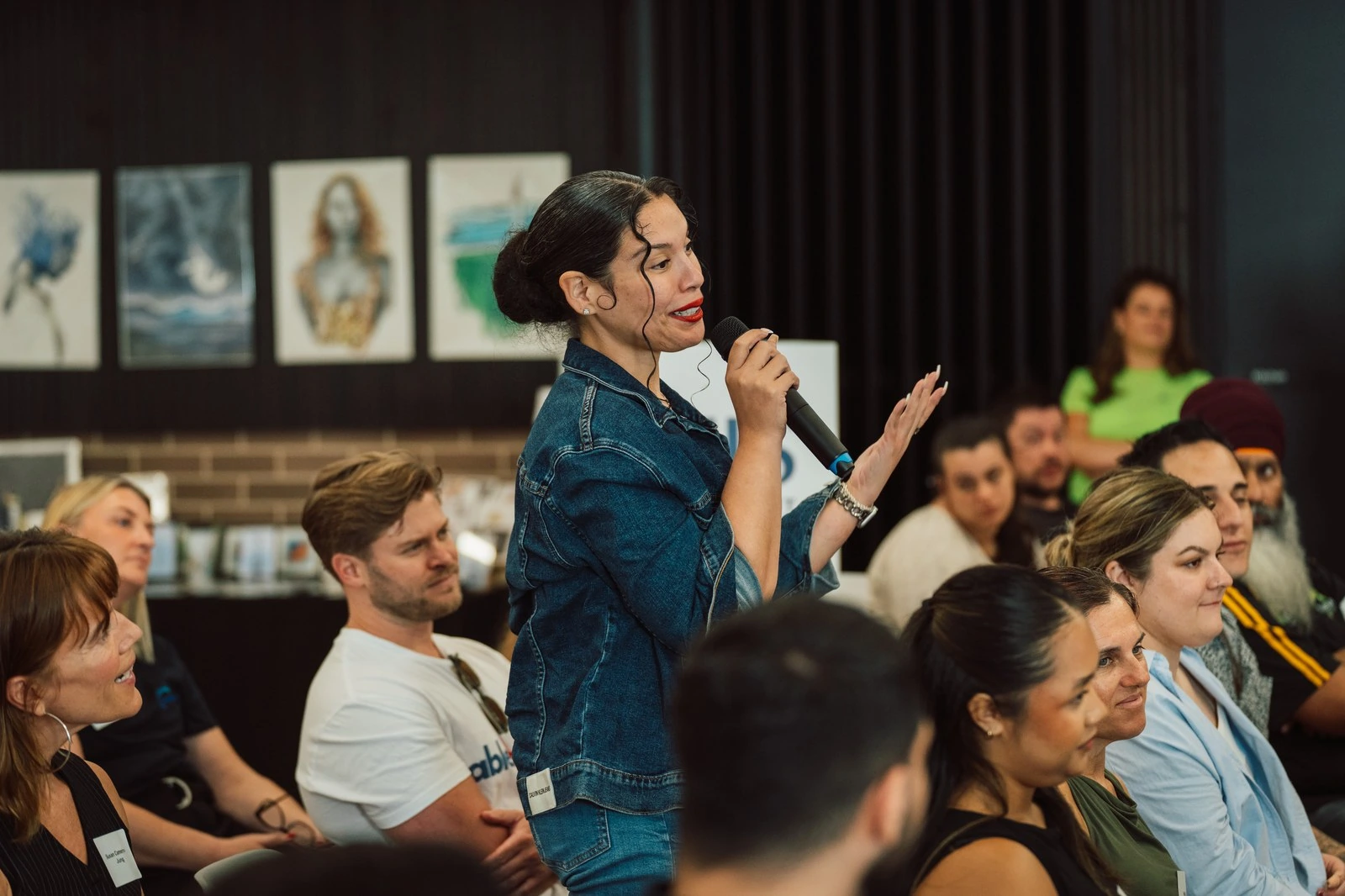 Yosmerys speaking to an audience about youth work practice